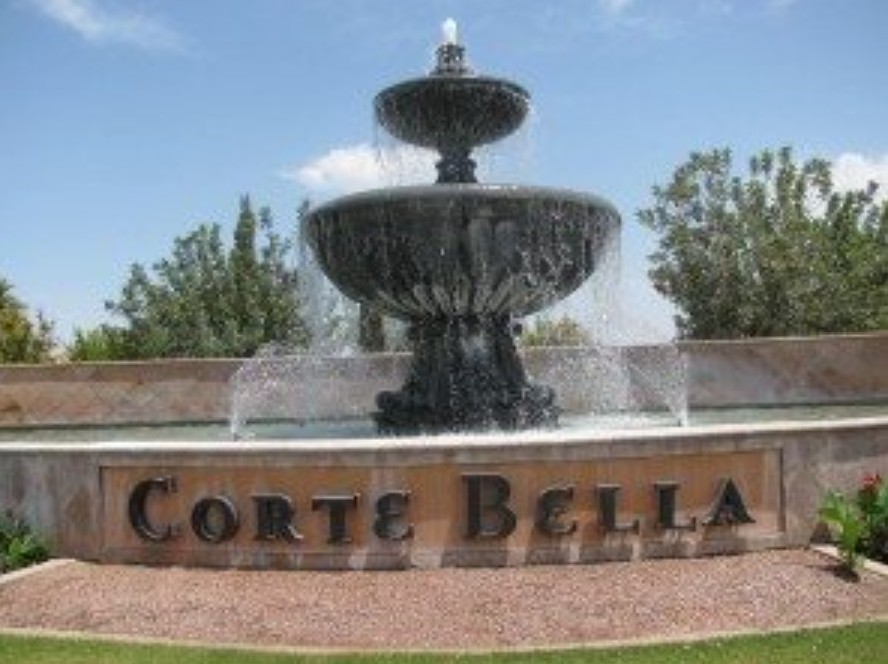 Corte Bella entrance — elegant tiered stone fountain with Corte Bella signage, gated country club community